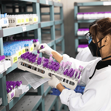 A person holding a blood specimen sample with a label applied that represents Brother Label Printers for Healthcare businesses like Awanui Labs